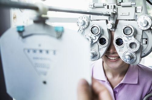 Patient behind a phoropter